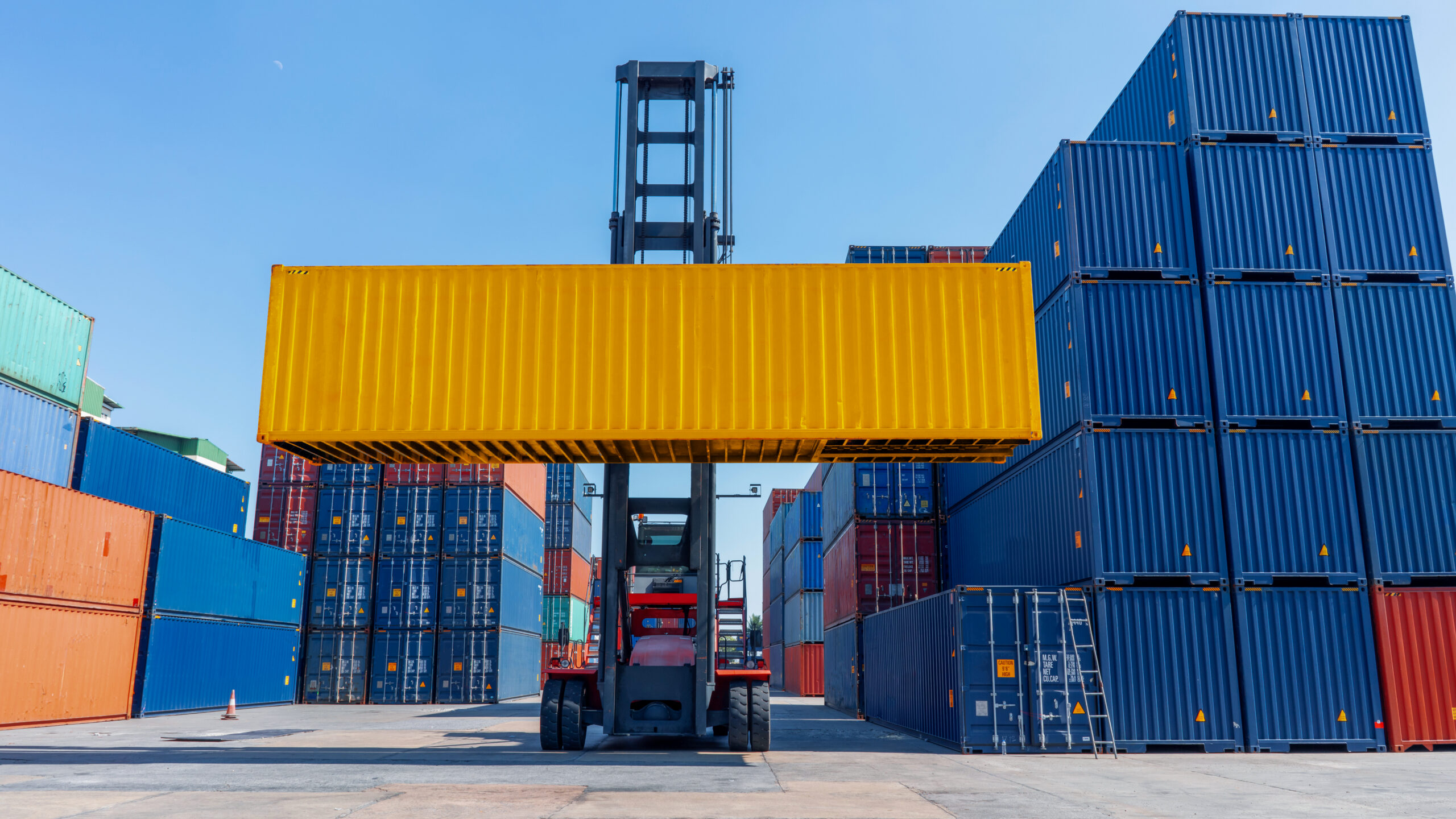 forklift working in the container cargo yard port loading cargo